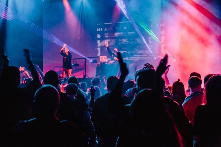 Band on stage with lasers and colored lights at a Sunset Strip club